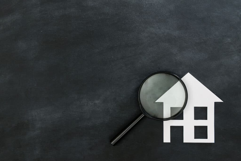 magnifying-glass-on-paper-house